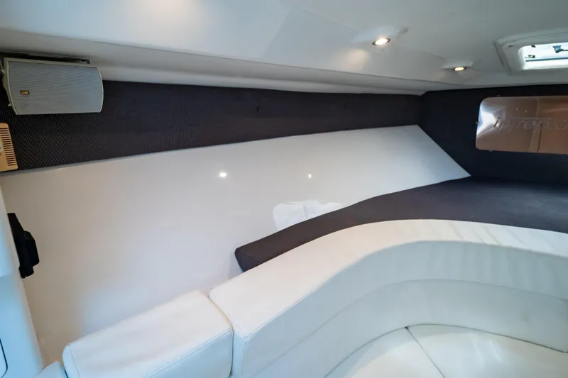  Yacht Photos Pics Interior of 2003 Intrepid 370 Cuddy boat, featuring cushioned seating and modern design.