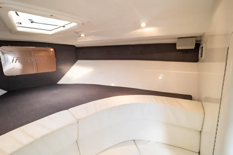  Yacht Photos Pics Interior of 2003 Intrepid 370 Cuddy, featuring cozy seating and modern lighting.