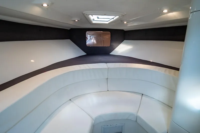  Yacht Photos Pics 2003 Intrepid 370 Cuddy interior with white seating and overhead lighting.