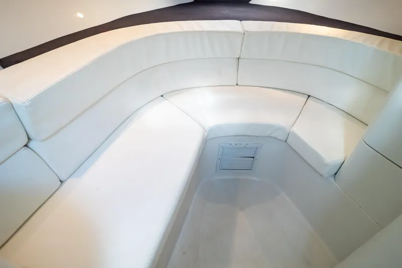  Yacht Photos Pics 2003 Intrepid 370 Cuddy interior with white cushioned seating.