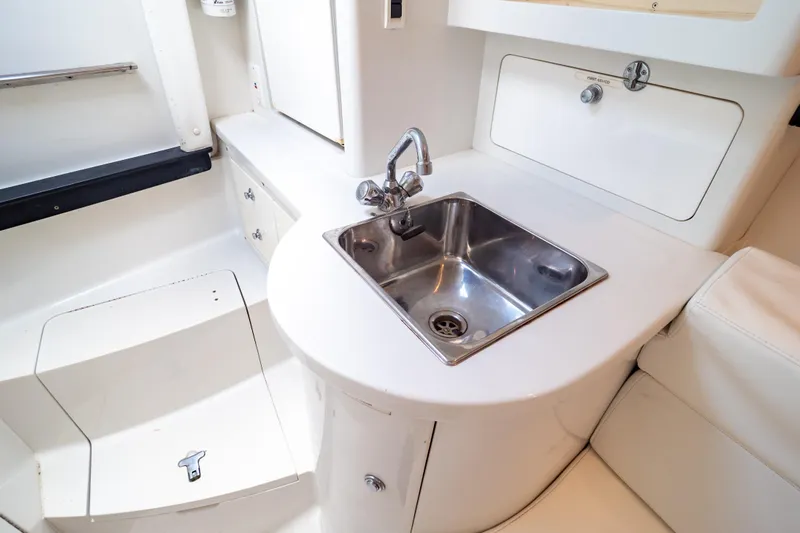  Yacht Photos Pics 2003 Intrepid 370 Cuddy interior with stainless steel sink and white cabinetry.