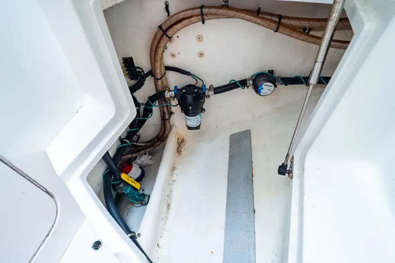  Yacht Photos Pics 2003 Intrepid 370 Cuddy interior showing plumbing and wiring components.