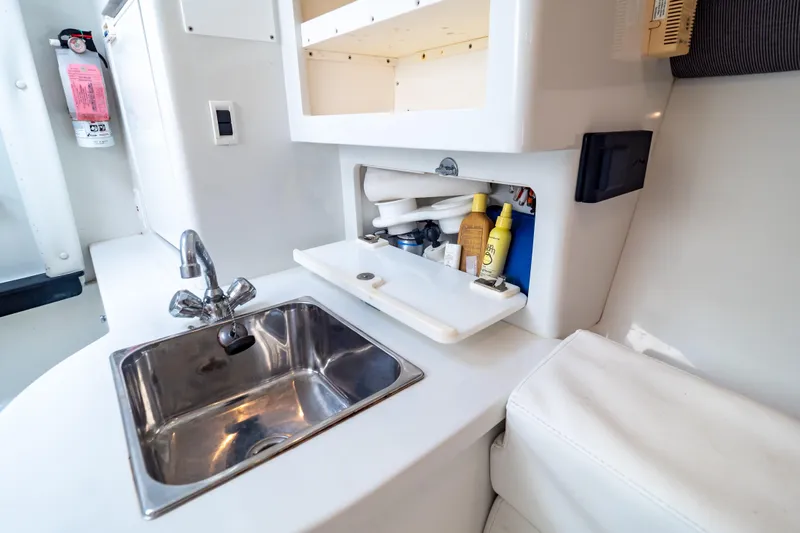  Yacht Photos Pics 2003 Intrepid 370 Cuddy boat interior with sink and storage compartment.