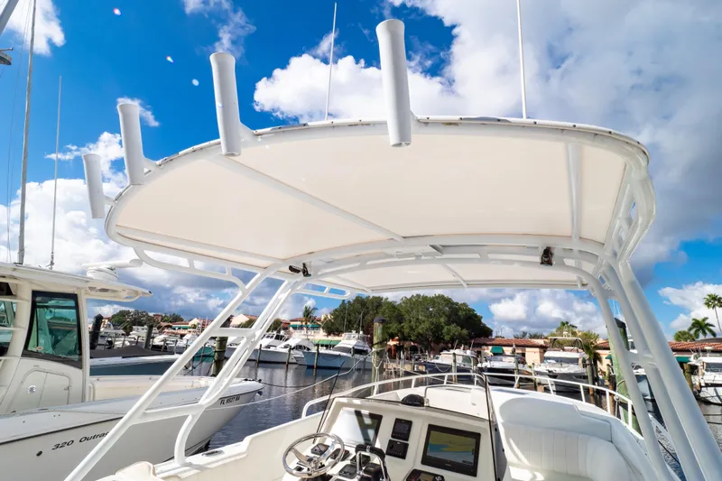  Yacht Photos Pics 2003 Intrepid 370 Cuddy boat at marina, clear sky, helm view.