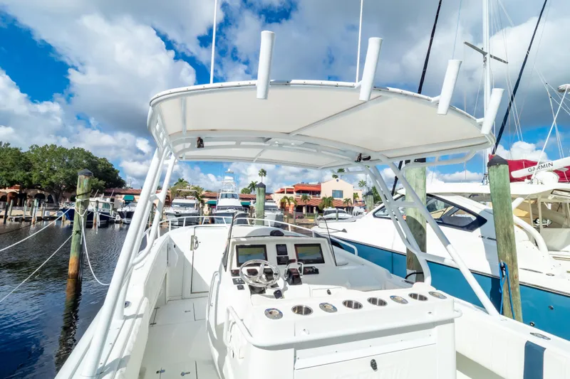  Yacht Photos Pics 2003 Intrepid 370 Cuddy boat docked at marina under blue sky.