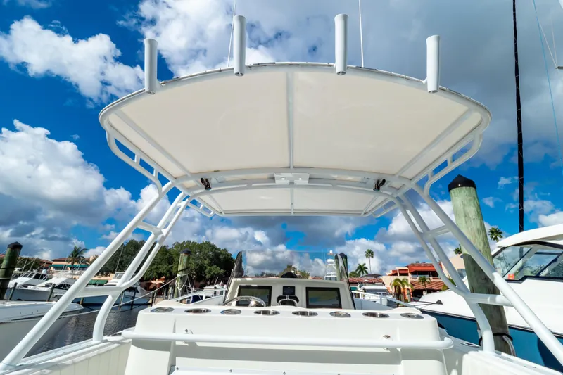  Yacht Photos Pics 2003 Intrepid 370 Cuddy boat with T-top, docked under a vibrant blue sky.