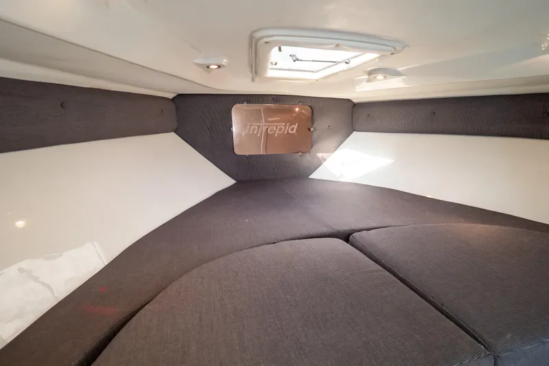  Yacht Photos Pics Interior cabin of 2003 Intrepid 370 Cuddy, featuring cushioned seating and overhead hatch.