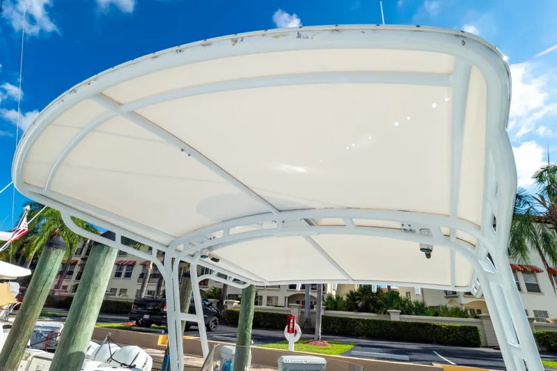  Yacht Photos Pics 2003 Intrepid 370 Cuddy boat canopy against a clear blue sky.