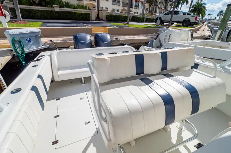  Yacht Photos Pics 2003 Intrepid 370 Cuddy boat interior with white and blue seating, docked at marina.