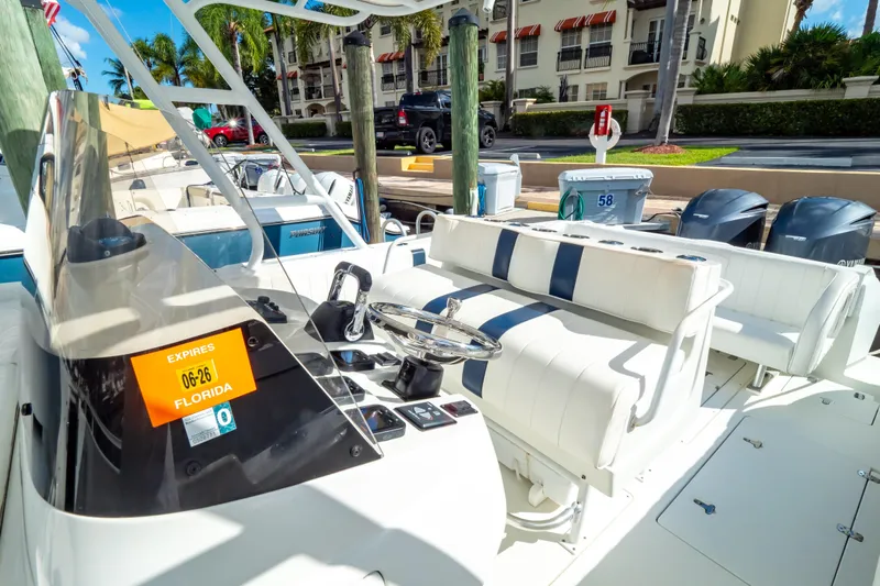  Yacht Photos Pics 2003 Intrepid 370 Cuddy boat interior with steering wheel and seating at a marina.