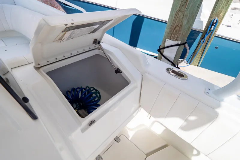  Yacht Photos Pics Open storage compartment on 2003 Intrepid 370 Cuddy boat with coiled hose inside.