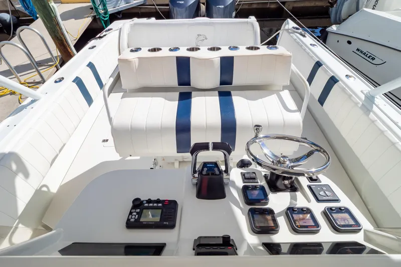  Yacht Photos Pics 2003 Intrepid 370 Cuddy boat cockpit with steering wheel and control panel.