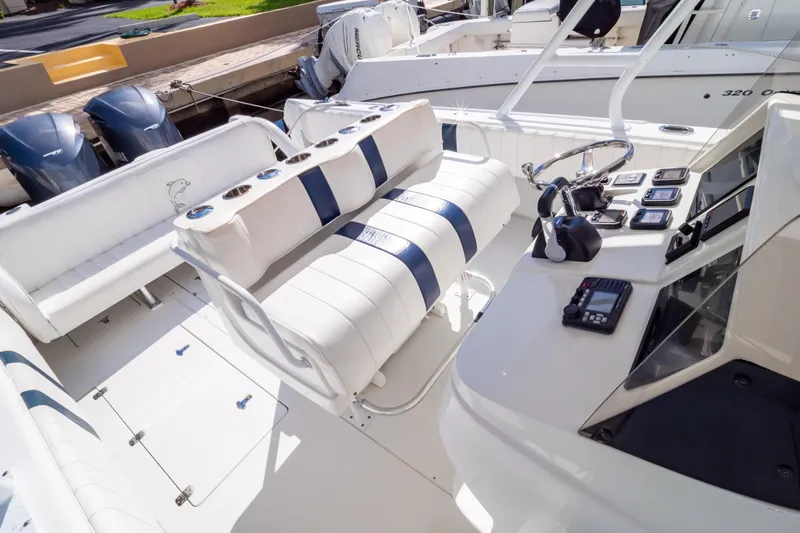  Yacht Photos Pics 2003 Intrepid 370 Cuddy boat interior with white seating and control panel.