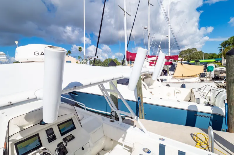  Yacht Photos Pics 2003 Intrepid 370 Cuddy boat docked at marina under cloudy sky.