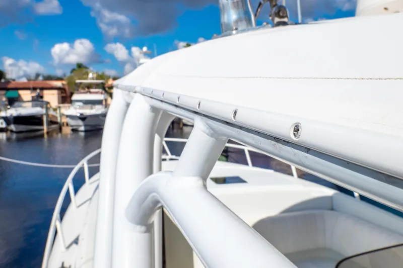  Yacht Photos Pics 2003 Intrepid 370 Cuddy boat detail with marina background under blue sky.