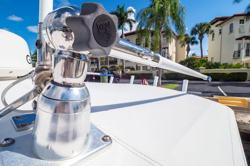  Yacht Photos Pics Close-up of a 2003 Intrepid 370 Cuddy boat's polished metal fixture with tropical background.