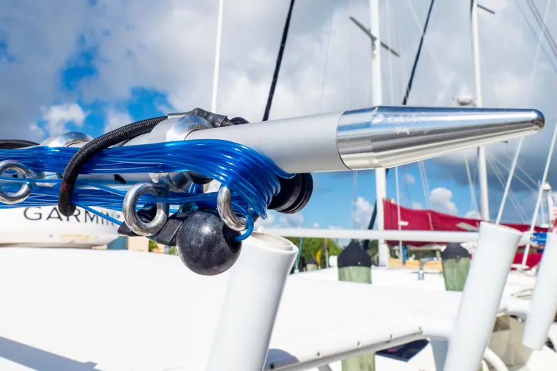  Yacht Photos Pics Close-up of a 2003 Intrepid 370 Cuddy boat's rigging and equipment under a blue sky.