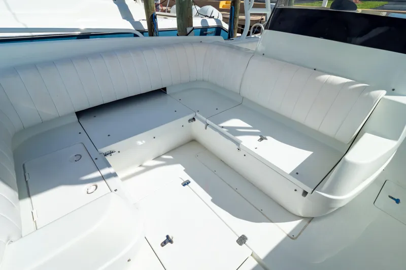  Yacht Photos Pics 2003 Intrepid 370 Cuddy boat interior with white cushioned seating and storage compartments.