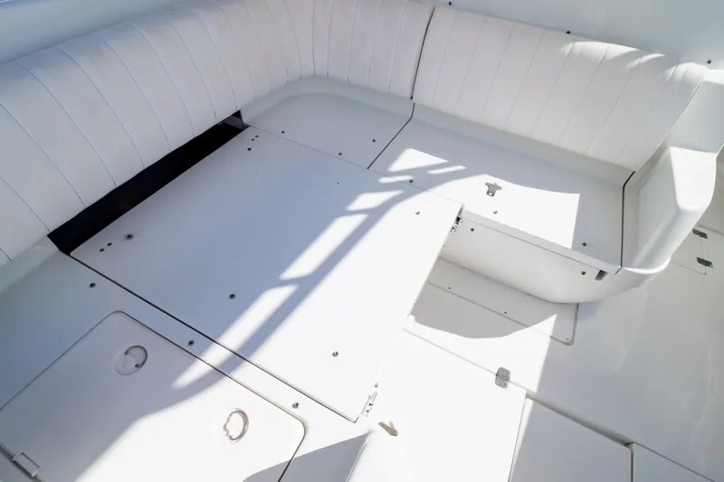  Yacht Photos Pics 2003 Intrepid 370 Cuddy boat interior with white cushioned seating and storage compartments.