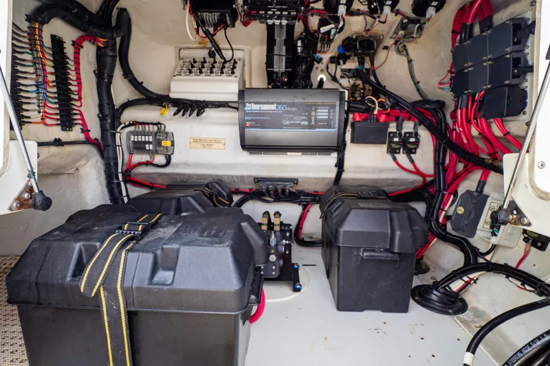  Yacht Photos Pics Electrical system of a 2003 Intrepid 370 Cuddy boat, featuring wiring and battery compartments.