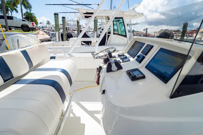  Yacht Photos Pics 2003 Intrepid 370 Cuddy boat interior with modern navigation equipment and seating.