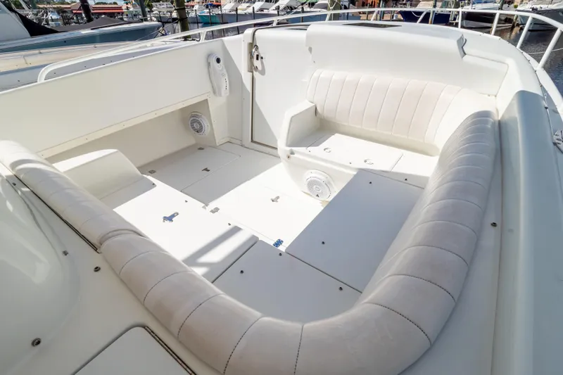  Yacht Photos Pics 2003 Intrepid 370 Cuddy boat interior with white cushioned seating and storage compartments.