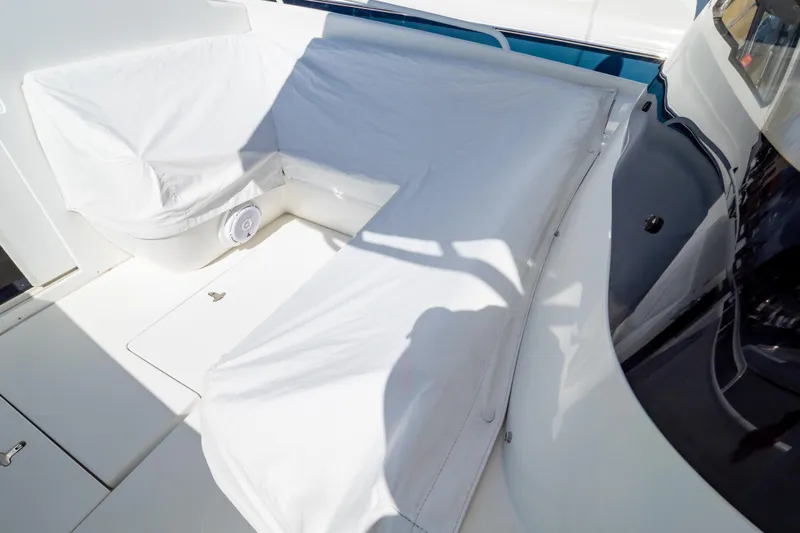  Yacht Photos Pics 2003 Intrepid 370 Cuddy boat interior with white seating and protective covers.