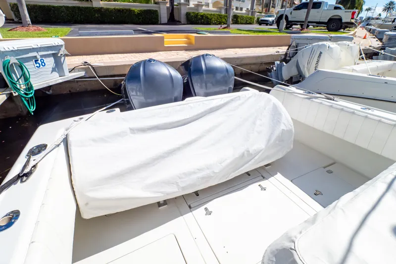  Yacht Photos Pics 2003 Intrepid 370 Cuddy boat with covered seating and dual outboard engines at dock.