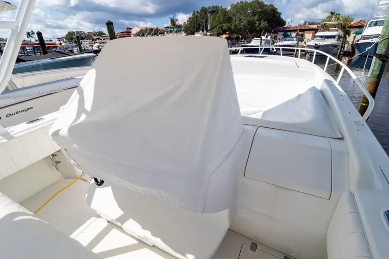  Yacht Photos Pics 2003 Intrepid 370 Cuddy boat interior with covered seating at marina.