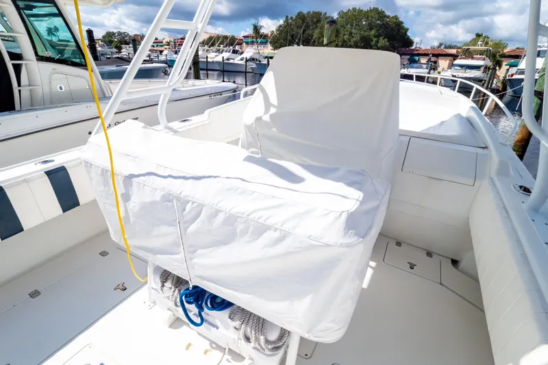  Yacht Photos Pics 2003 Intrepid 370 Cuddy boat interior with covered seating, docked at marina.