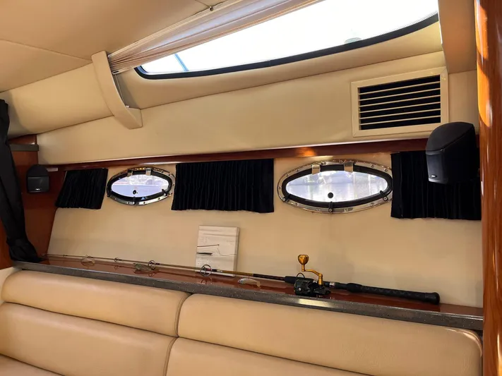 Souper Tuscan Yacht Photos Pics Interior of 2011 Regal 35 Express Cruiser with portholes and fishing rod storage.