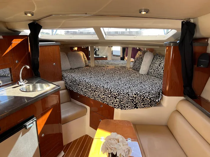 Souper Tuscan Yacht Photos Pics 2011 Regal 35 Express Cruiser interior with bed, kitchenette, and seating area.