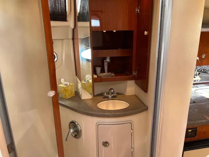 Souper Tuscan Yacht Photos Pics 2011 Regal 35 Express Cruiser bathroom with sink, mirror, and wooden cabinet.