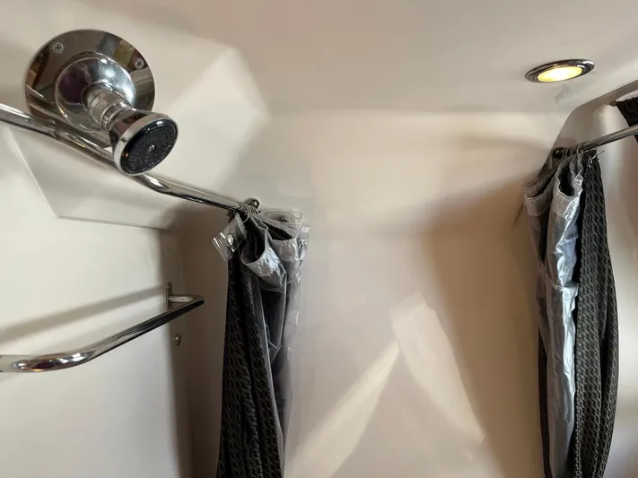 Souper Tuscan Yacht Photos Pics Shower area in 2011 Regal 35 Express Cruiser with chrome fixtures and curtains.