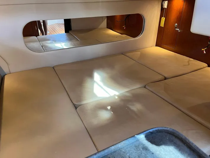 Souper Tuscan Yacht Photos Pics 2011 Regal 35 Express Cruiser interior cabin with beige cushions and wall mirror.