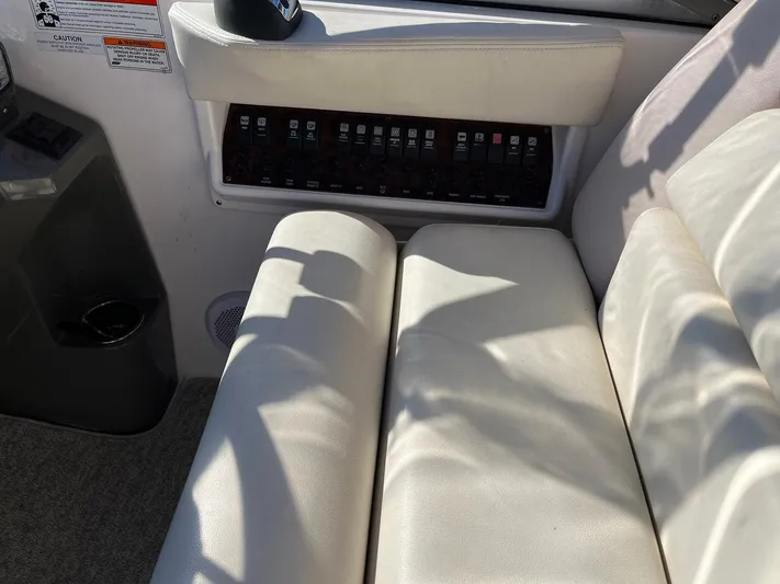 Souper Tuscan Yacht Photos Pics 2011 Regal 35 Express Cruiser interior with white seating and control panel.