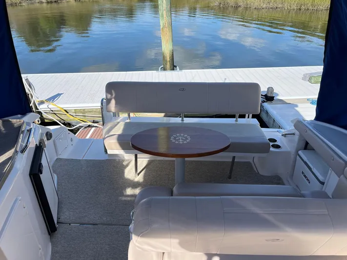 Souper Tuscan Yacht Photos Pics 2011 Regal 35 Express Cruiser interior with seating and table by the water.