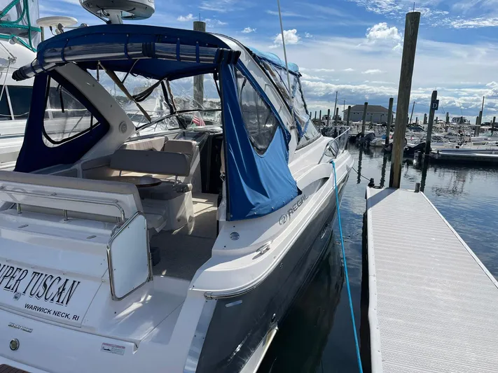 Souper Tuscan Yacht Photos Pics 2011 Regal 35 Express Cruiser docked at marina under blue sky.