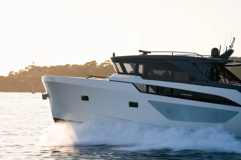 Bgx63 Yacht Photos Pics 2024 Bluegame BGX63 yacht cruising on calm waters at sunset.