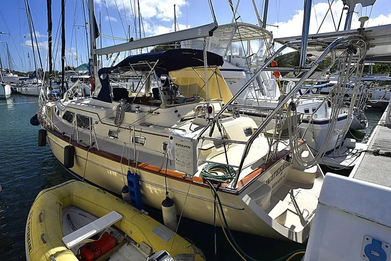Watermark Lll Yacht Photos Pics Island Packet 445 sailboat, 2005 model, docked at marina with inflatable dinghy nearby.