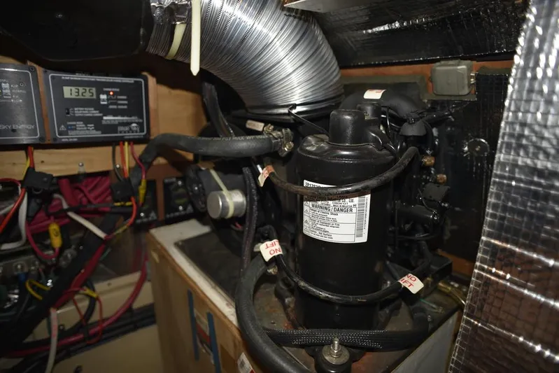 Watermark Lll Yacht Photos Pics Engine room of 2005 Island Packet 445 sailboat, featuring mechanical components and wiring.