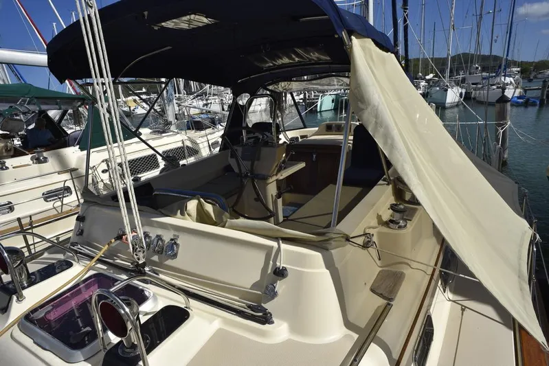 Watermark Lll Yacht Photos Pics 2005 Island Packet 445 sailboat with covered cockpit, docked in a marina.