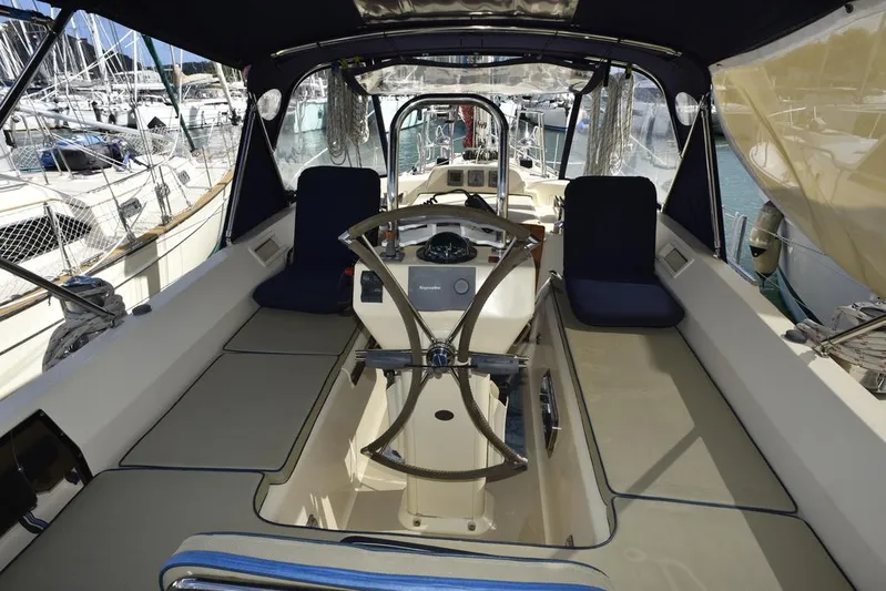 Watermark Lll Yacht Photos Pics 2005 Island Packet 445 sailboat cockpit with steering wheel and seating in marina.