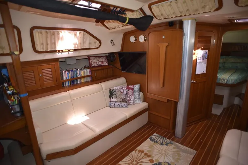Watermark Lll Yacht Photos Pics Interior of 2005 Island Packet 445 yacht with cozy seating and wooden accents.