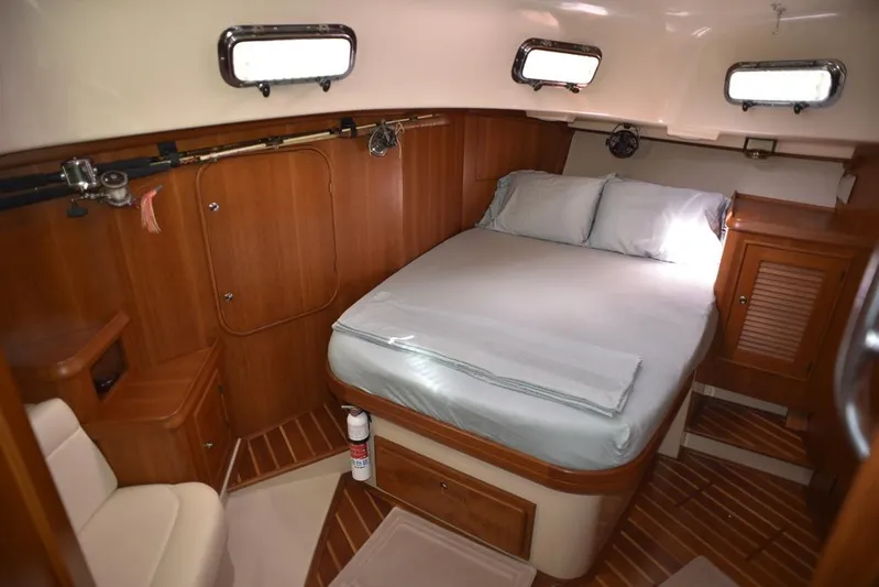 Watermark Lll Yacht Photos Pics Luxurious cabin interior of 2005 Island Packet 445 yacht with cozy bed and wooden furnishings.