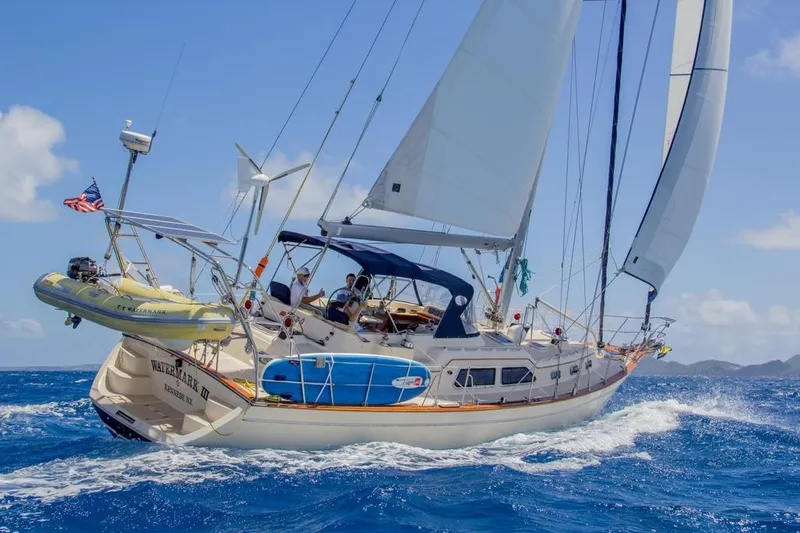 Watermark Lll Yacht Photos Pics Sailing yacht Island Packet 445, 2005 model, cruising on open sea with clear blue skies.