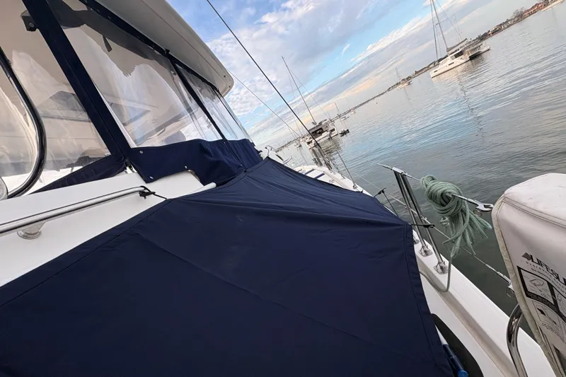 Flip Flops Yacht Photos Pics 2017 Leopard 48 yacht with blue cover, docked in calm waters.