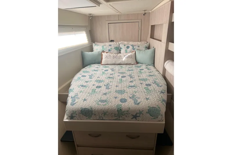 Flip Flops Yacht Photos Pics Cozy bedroom in 2017 Leopard 48 yacht with nautical-themed bedding and decorative pillows.
