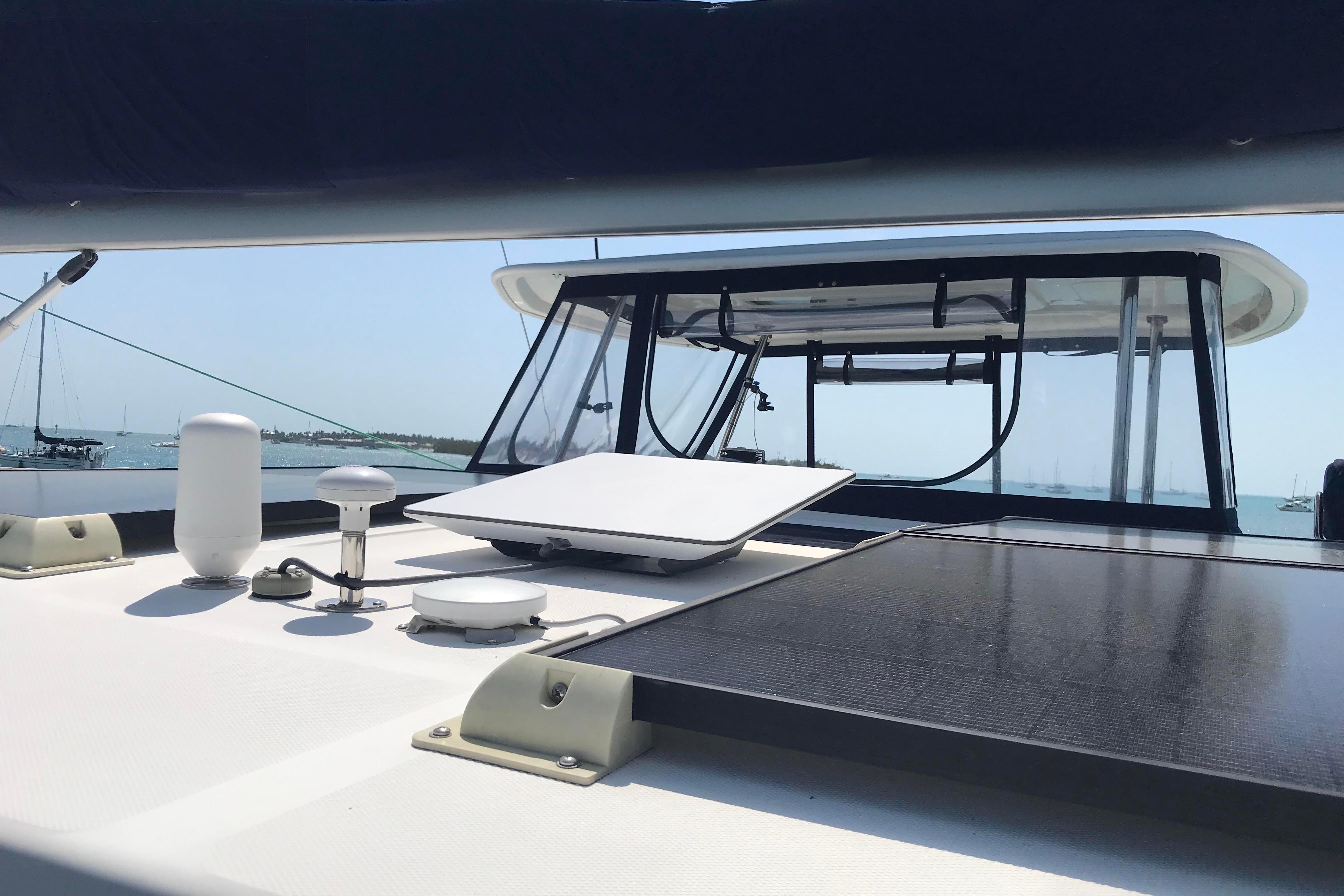 2017 Leopard 48 yacht deck with solar panels and equipment, anchored in a sunny harbor.