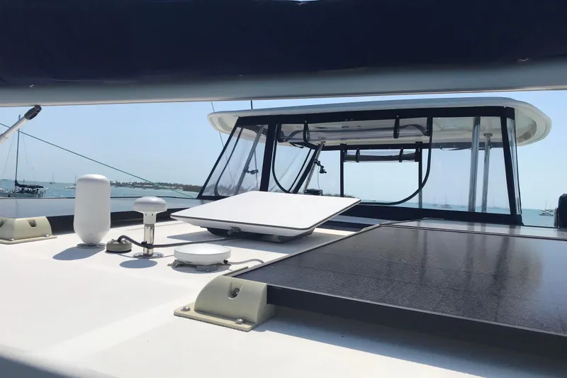 Flip Flops Yacht Photos Pics 2017 Leopard 48 yacht deck with solar panels and equipment, anchored in a sunny harbor.